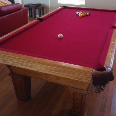 8' Olhausen Pool Table...Red felt...good condition...balls, cues, and rack included.